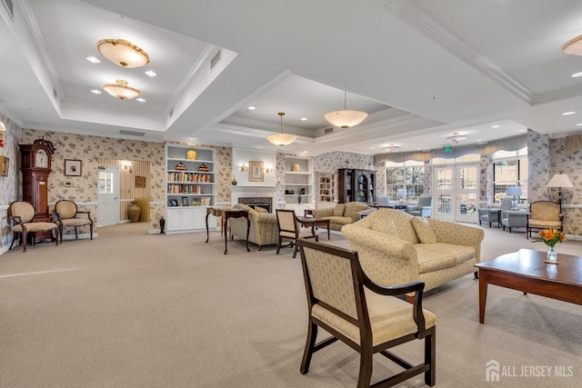 living room featuring light carpet, a tray ceiling, ornamental molding, and french doors