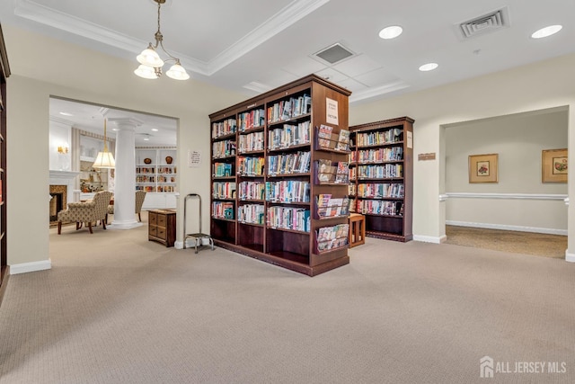 sitting room with crown molding, a raised ceiling, decorative columns, and light carpet