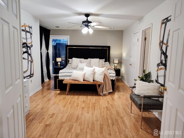 bedroom with ceiling fan and light hardwood / wood-style flooring