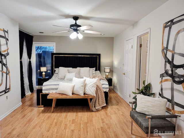 bedroom with ceiling fan and light hardwood / wood-style floors