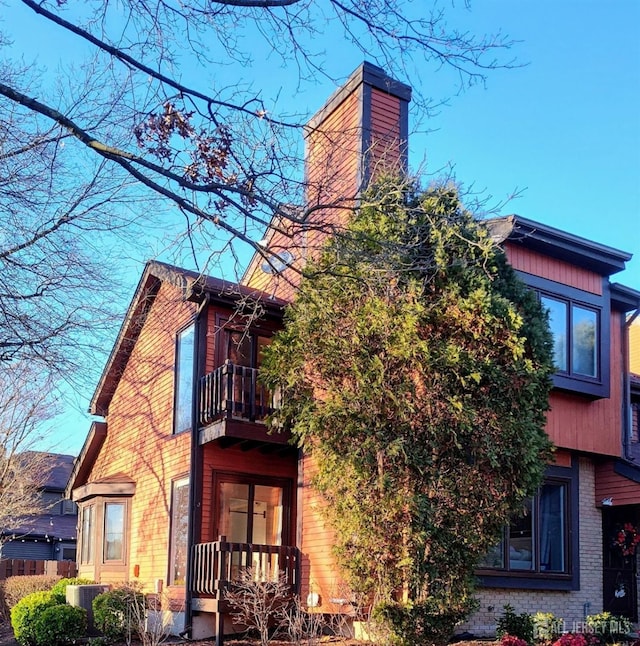 view of home's exterior with a balcony and cooling unit