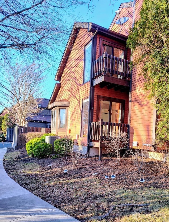 view of property exterior with a balcony and central air condition unit