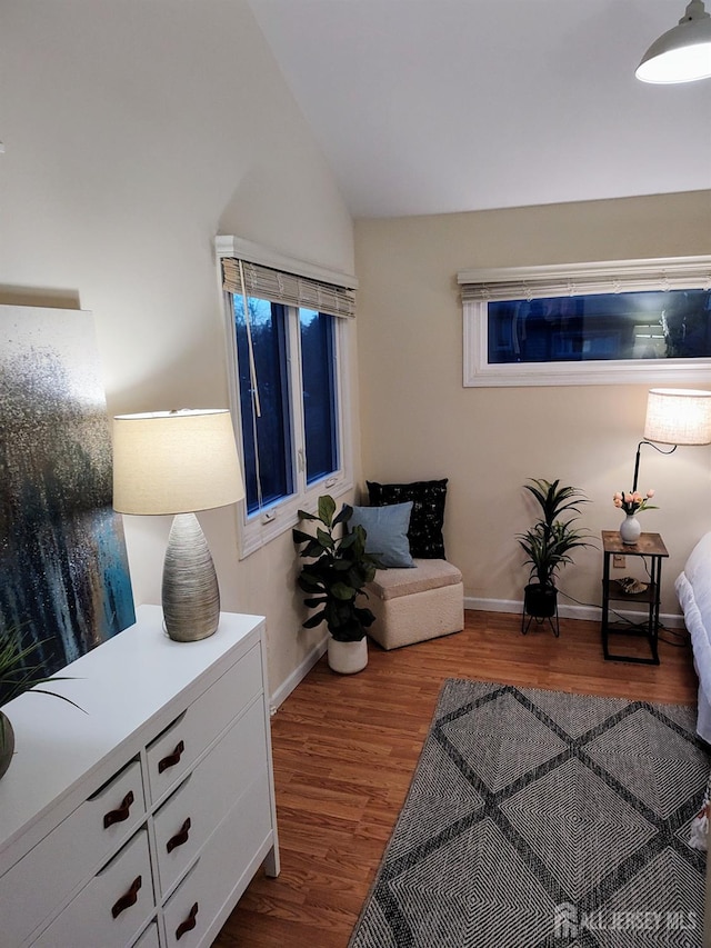 sitting room featuring hardwood / wood-style flooring and lofted ceiling