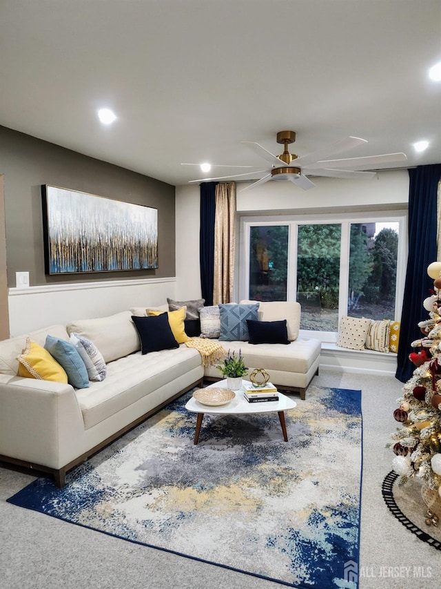 living room featuring ceiling fan and carpet