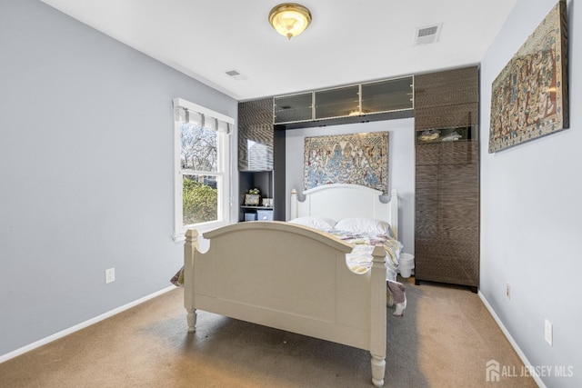 bedroom with carpet floors, baseboards, and visible vents