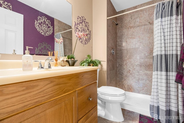 full bathroom featuring toilet, a tile shower, and vanity