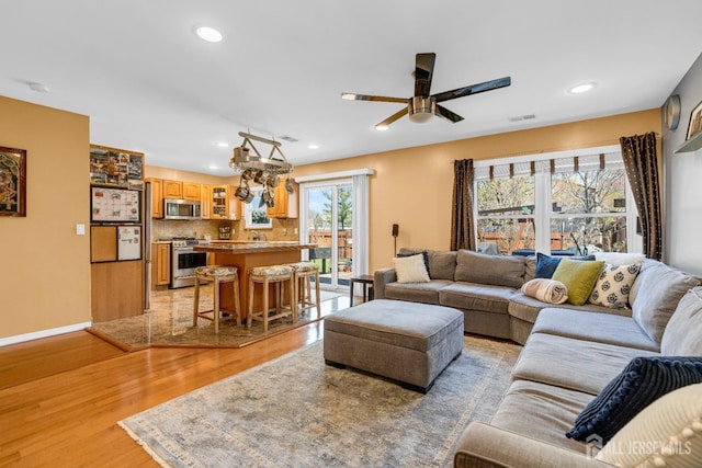 living room with recessed lighting, ceiling fan, visible vents, and light wood-style floors