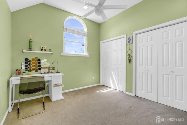 interior space with baseboards, ceiling fan, and lofted ceiling