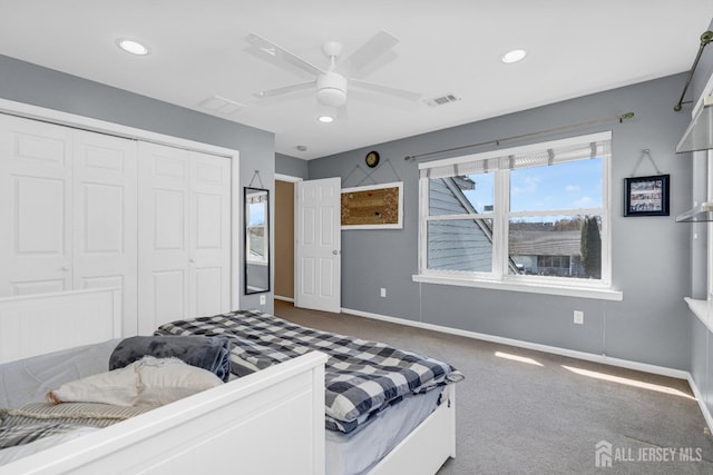 bedroom with carpet flooring, a ceiling fan, baseboards, visible vents, and a closet