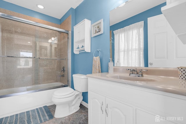 bathroom with toilet, tile patterned floors, shower / bath combination with glass door, and vanity