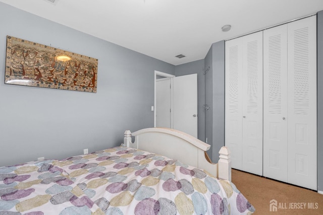 bedroom featuring a closet, carpet, and visible vents