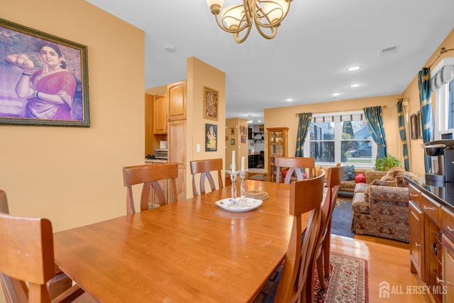 dining space with recessed lighting, a chandelier, light wood-style flooring, and visible vents
