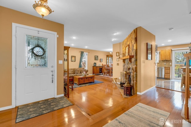 foyer entrance featuring recessed lighting, baseboards, and light wood finished floors