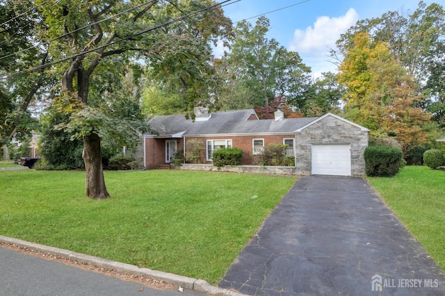 single story home featuring a garage and a front lawn