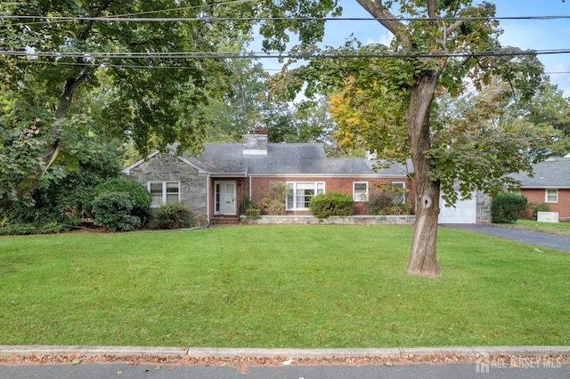 single story home with a front yard and a garage