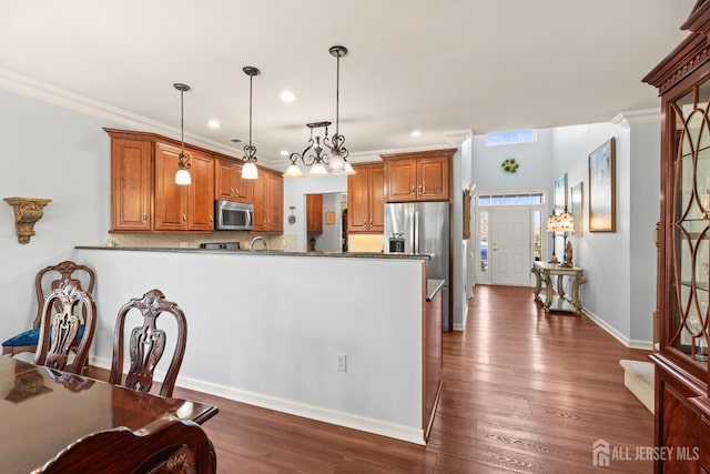 31 Mcgowan Ct, Old Bridge, NJ 08857 - kitchen with appliances with stainless steel finishes, recessed lighting, brown cabinets, tasteful backsplash, and a peninsula