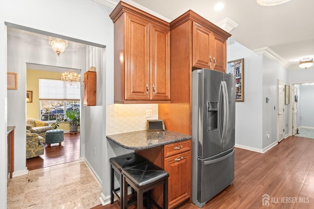 31 Mcgowan Ct, Old Bridge, NJ 08857 - kitchen with stainless steel fridge with ice dispenser, brown cabinets, a chandelier, ornamental molding, and dark stone countertops