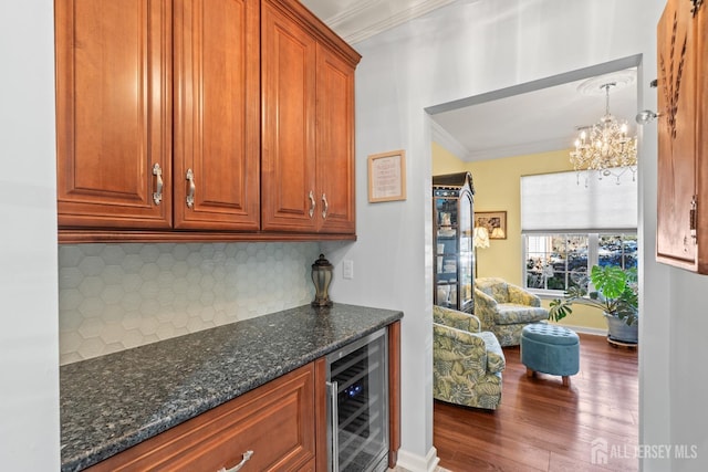 31 Mcgowan Ct, Old Bridge, NJ 08857 - indoor dry bar with beverage cooler, ornamental molding, backsplash, dark wood finished floors, and a chandelier