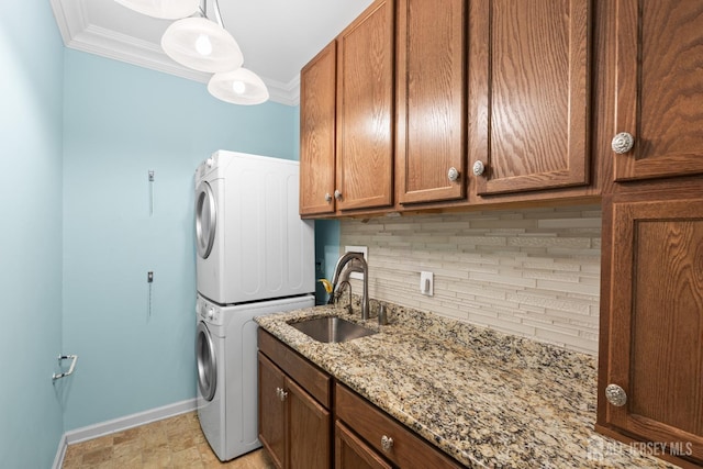 31 Mcgowan Ct, Old Bridge, NJ 08857 - laundry room featuring stacked washer and clothes dryer, crown molding, and cabinet space