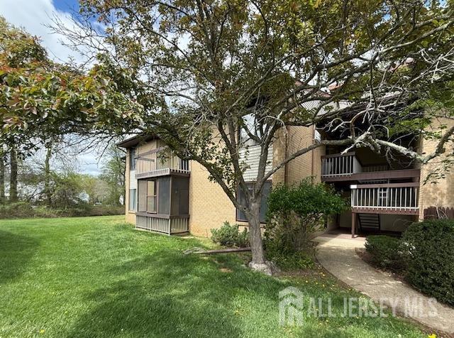 54 Amberly Dr Unit A, Manalapan, NJ 07726 - view of side of home with a balcony and a yard