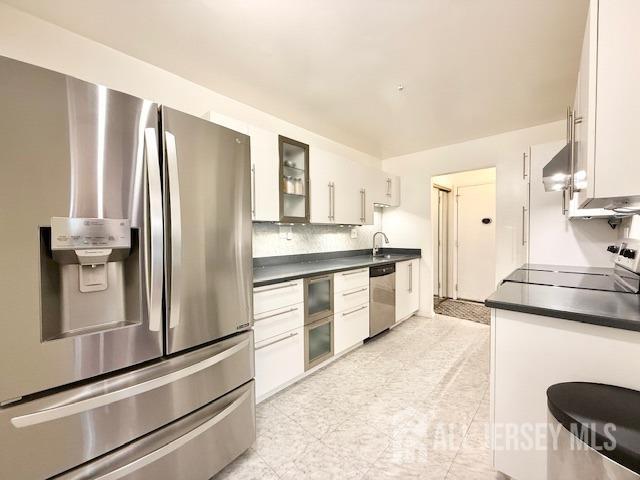 54 Amberly Dr Unit A, Manalapan, NJ 07726 - kitchen with stainless steel appliances, white cabinets, and dark countertops