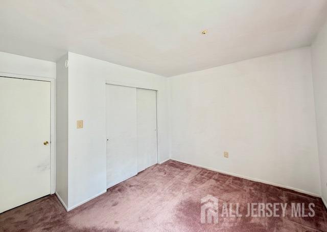 54 Amberly Dr Unit A, Manalapan, NJ 07726 - unfurnished bedroom with carpet and a closet