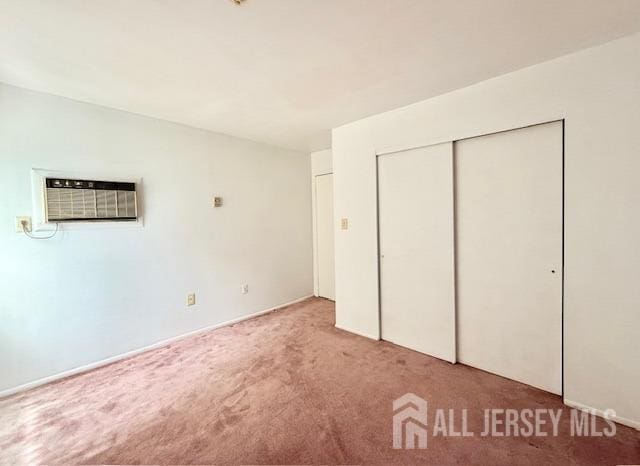 54 Amberly Dr Unit A, Manalapan, NJ 07726 - unfurnished bedroom featuring light carpet, a wall unit AC, and a closet