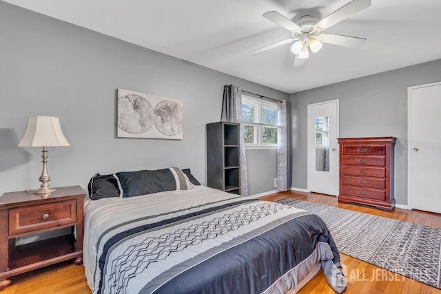 bedroom featuring baseboards, ceiling fan, and wood finished floors