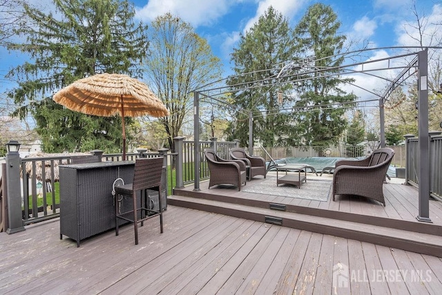 wooden deck featuring a fenced backyard, a swimming pool, and an outdoor living space