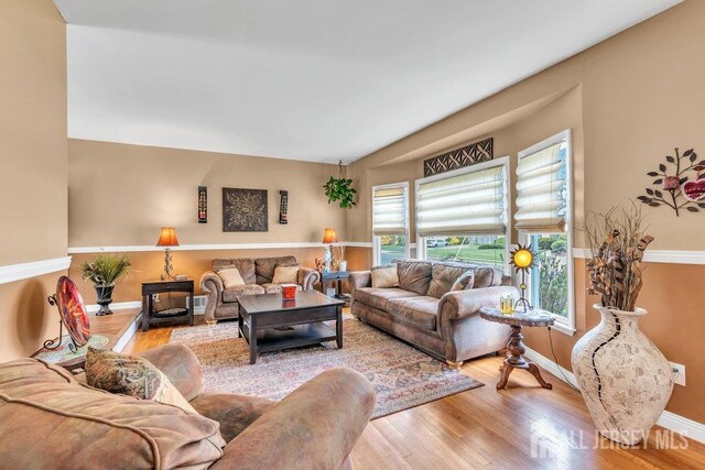 living area featuring baseboards and wood finished floors