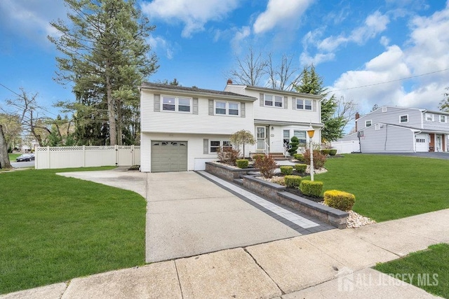 view of front of house featuring concrete driveway, an attached garage, fence, and a front yard