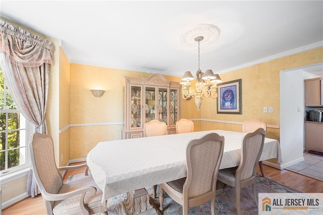 254 Wyoming Ave, Spotswood, NJ 08884 - dining room with a chandelier, light wood-style floors, and crown molding