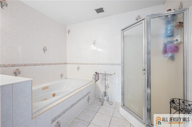 254 Wyoming Ave, Spotswood, NJ 08884 - bathroom featuring tile walls, a stall shower, a whirlpool tub, and tile patterned flooring