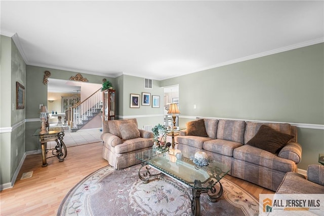 254 Wyoming Ave, Spotswood, NJ 08884 - living room featuring wood finished floors, stairs, and crown molding