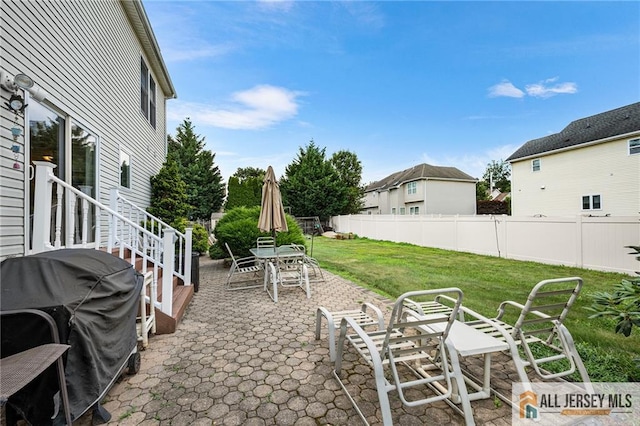 254 Wyoming Ave, Spotswood, NJ 08884 - fenced backyard with a grill, a patio, and outdoor dining area