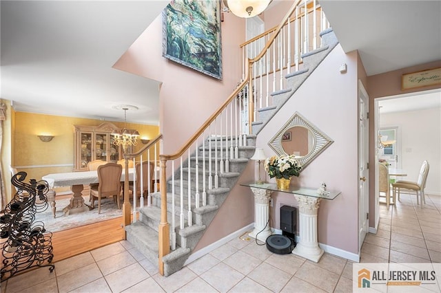 254 Wyoming Ave, Spotswood, NJ 08884 - stairs with tile patterned flooring and a chandelier