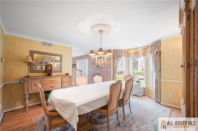 254 Wyoming Ave, Spotswood, NJ 08884 - dining room with a chandelier, light wood finished floors, and crown molding