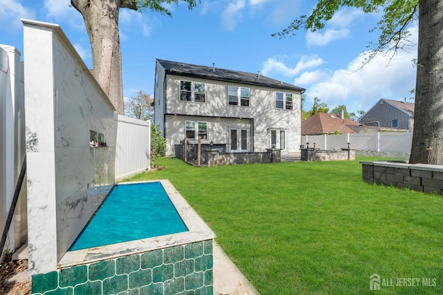 back of house featuring french doors and a patio