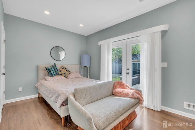 bedroom featuring baseboards, access to outside, french doors, wood finished floors, and recessed lighting