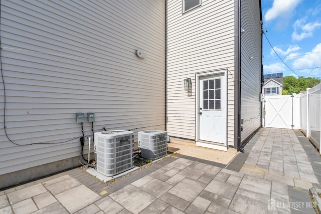 view of patio / terrace featuring central AC, a gate, and fence