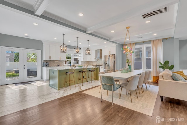 dining space with beamed ceiling, french doors, recessed lighting, light wood-style flooring, and ornamental molding