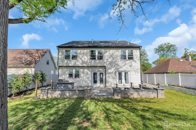 rear view of house featuring french doors and a patio area