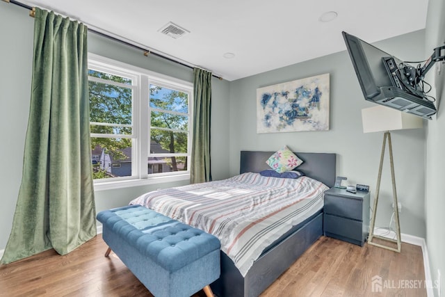 bedroom featuring baseboards and wood finished floors