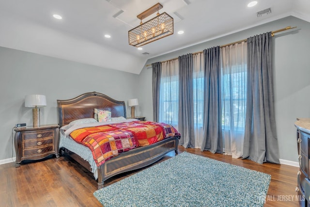 bedroom featuring lofted ceiling, baseboards, wood finished floors, and recessed lighting