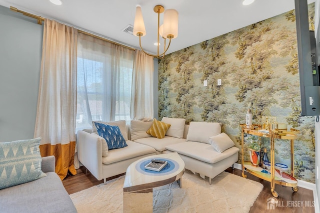 living area with wood finished floors, recessed lighting, and a chandelier