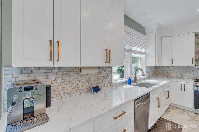 kitchen featuring a sink, stainless steel appliances, white cabinets, and light stone countertops