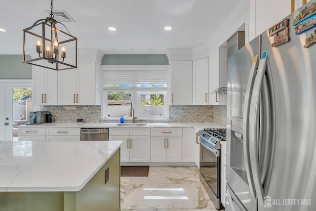 kitchen featuring stainless steel appliances, a sink, light marble finish flooring, tasteful backsplash, and recessed lighting