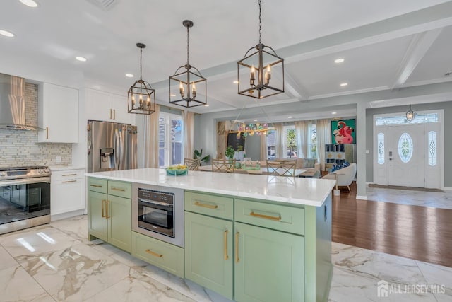 kitchen featuring stainless steel appliances, green cabinets, a chandelier, tasteful backsplash, and recessed lighting