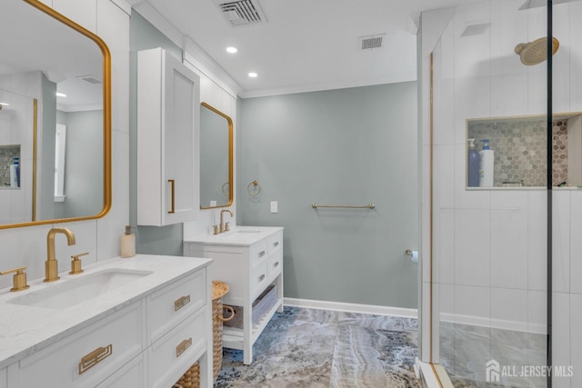full bath with a stall shower, two vanities, crown molding, baseboards, and recessed lighting