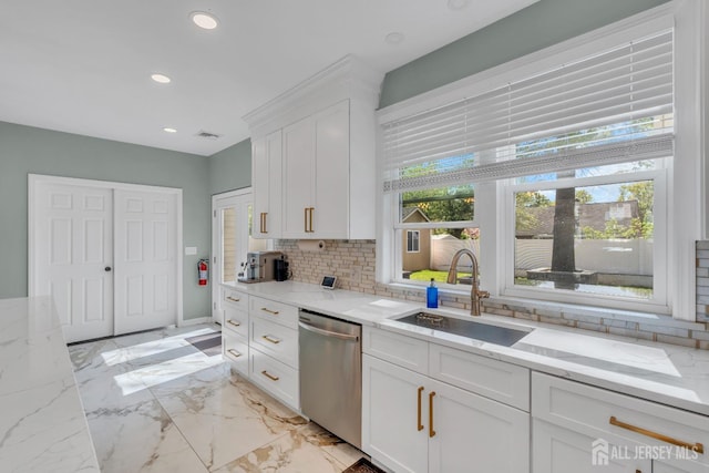 kitchen with dishwasher, a sink, tasteful backsplash, white cabinetry, and recessed lighting